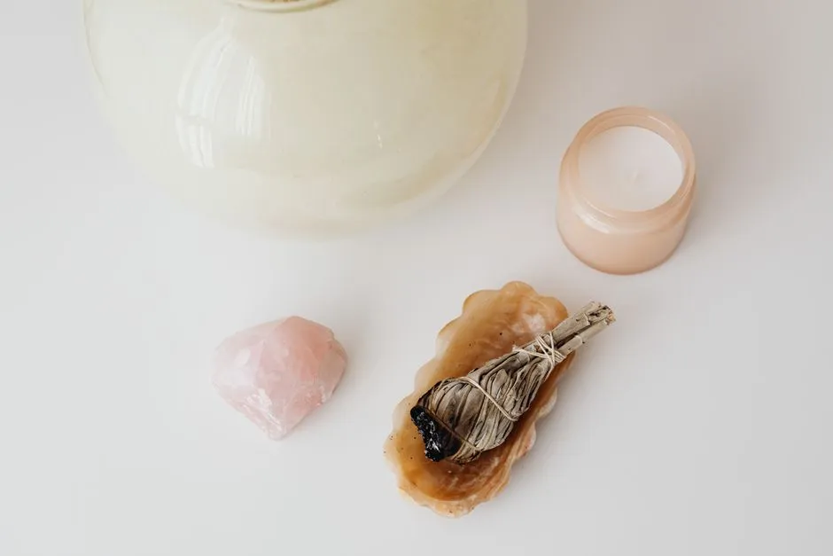 Crystals arranged with lit candles and incense for a cleansing ritual