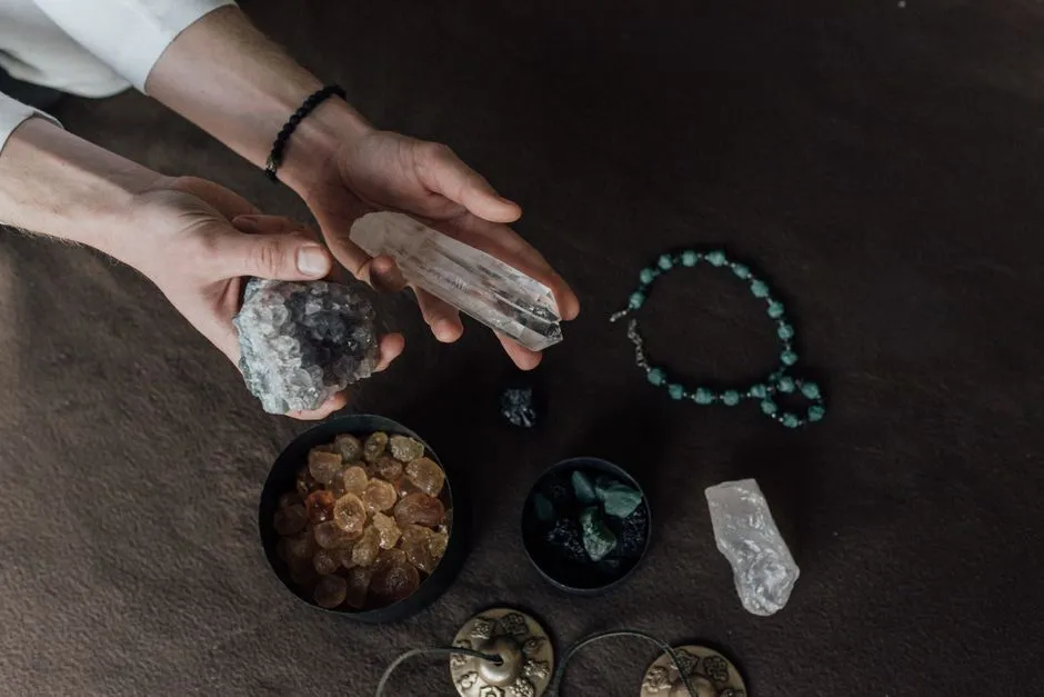 Person holding a handful of polished healing crystals